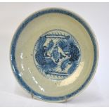 A blue and white dish decorated with a pair of mythological birds;
