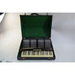 A Scandalli piano accordion with black plastic body, 120 pegs and ivorine keys,