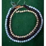 Three rows of beads without snaps, including blue dyed rock crystal, black agate,