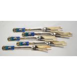 Liberty: a set of five silver and enamel pastry forks with stylised foliate design finials in the