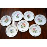 A set of seven Victorian, Staffordshire China dishes; each one with a floral design, 22cm diameter,