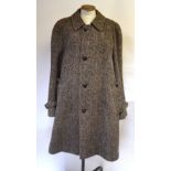 An Aquascutum herringbone Irish wool tweed gentleman's overcoat with 'football' leather buttons and