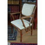 An Arts & Crafts period walnut framed and part upholstered chapel style armchair