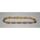 A 9ct yellow and white gold link bracelet set with amethyst and small eight-cut diamonds, 18.