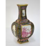 A famille rose vase decorated en-cameau with panels depicting retreats in mountainous landscapes on
