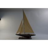 A wooden model of a J-class yacht,