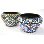 An associated pair of of copper and enamel bowls, possibly Syrian, each one decorated in white,