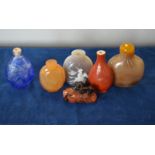 Six Chinese snuff bottles including: one in coral-red monochrome;