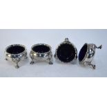 A set of four George II Scottish silver circular open salts with crimped rims and hoof feet with