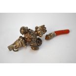 An early Victorian silver infant's rattle, ornately chased with foliate decoration, with whistle,