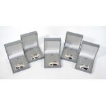 A set of five modern silver decanter labels for Scotch, Rum, Gin,