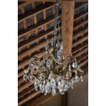 A cast metal eight-branch electrolier with twelve sconces,