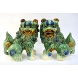 A pair of susancai and blue decorated, Buddhist Lions,