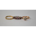 A synthetic ruby and diamond two row half eternity ring, white metal set,