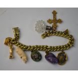 A gilt metal curb bracelet with various charms attached including gold Statue of Liberty,