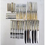 A set of six each table knives and forks with loaded silver handles,