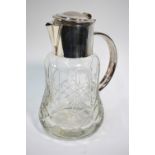 A heavy cut glass cocktail jug of waisted form, with electroplated collar, handle,