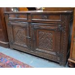 A 17th century and later carved oak cabinet,