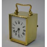A small brass cased boudoir clock with rectangular enamel dial