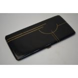 An Art Deco black lacquer and gilt brass cigarette case, 17 x 8.