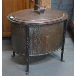 A large ovoid lidded copper coal box, raised on a wrought iron frame,