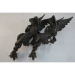 A pair of bronze furniture mounts cast as Melusine (winged watersprite with two tails),