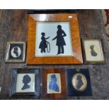 A silhouette cut-out of a Victorian father and son with hoop, 23 x 21 cm, in maple frame,