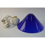 A ceramic adjustable-height ceiling light with blue and white case glass conical shade