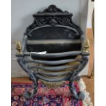 A Regency-style cast iron and brass fire basket of serpentine form,