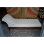 A continental scroll end chaise longue raised on moulded splayed legs,