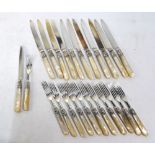 A set of twelve each silver dessert knives and forks with ornate scrolling ferrules and
