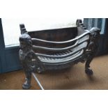 A Georgian style cast iron fire basket with lion head finials to paw feet,