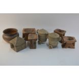 A selection of African tribal carved wood objects including flour mills and covered pots to/w a