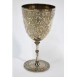 A Victorian engraved silver chalice decorated with scrolling foliage,