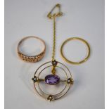 A circular open style brooch set amethyst and four small pearls,