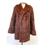 A dark mink fur coat with deep collar and a russet squirrel fur coat, both approx.