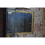 A Victorian Aesthetic period ebonised and gilt framed overmantel, with original plate,