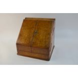A Victorian burr walnut stationery box with two doors enclosing perpetual calendar above slotted