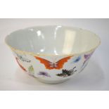 A famille rose bowl, decorated with a design of butterflies or other invertebrates; 17cm diameter,