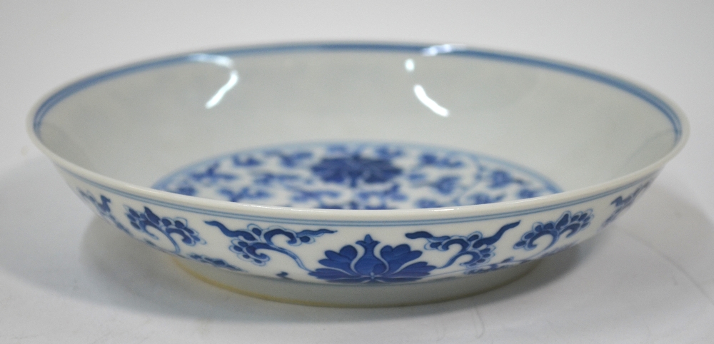 A blue white circular dish decorated wit