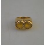 A yellow metal set with two heart shaped