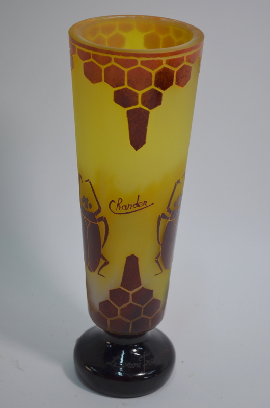 A yellow-ground glass vase on circular f