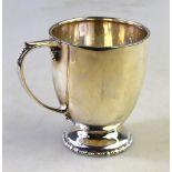 A silver Christening mug of ovoid form, on raised beaded foot, London 1939, 3 oz,