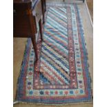 An antique Kurdish runner with multicoloured diamond stripes incorporating geometric designs,