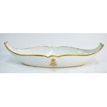 A Sevres boat-shaped dish in white monochrome with gilt border and N Imperial monogram; 27.