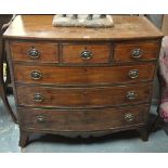 A George III bowfront mahogany chest of three short drawers over three graduated boxwood inlaid