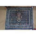 A small Persian Brojerd rug, the stylised floral design on dark blue ground within multi-borders,
