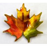 David Andersen - A Norwegian silver gilt maple leaf brooch enamelled in autumnal colours,