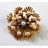 A 9ct yellow gold floral brooch with sapphire and pearl centre with pearls around,