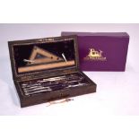 A fine quality inlaid rosewood case of drawing instruments, in nickel, polished steel, ivory,